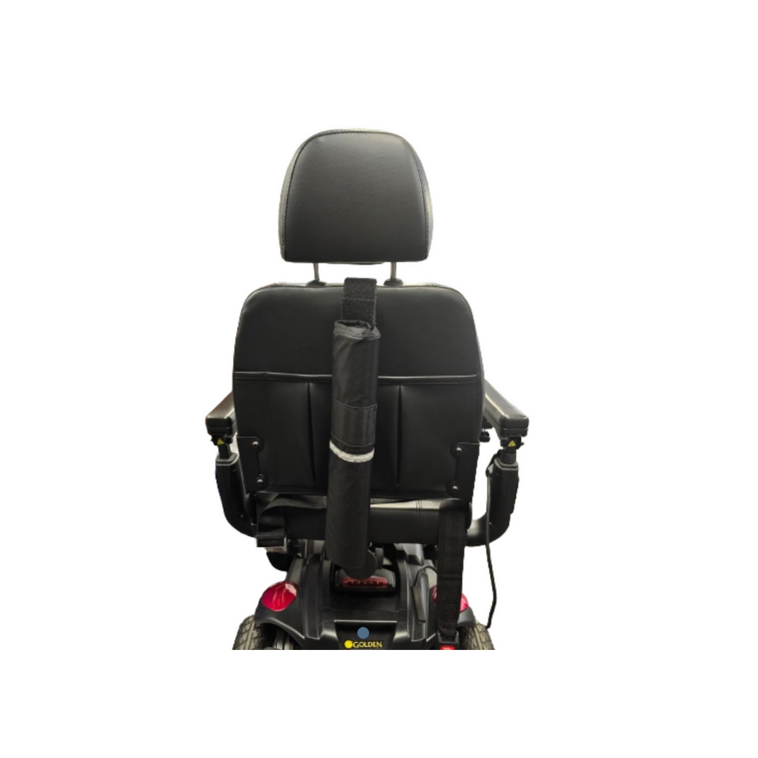 A Golden Tech Accessories quad cane holder is attached to the center of a black mobility scooter seat, shown from the back, making it a practical accessory for power chairs and scooters.